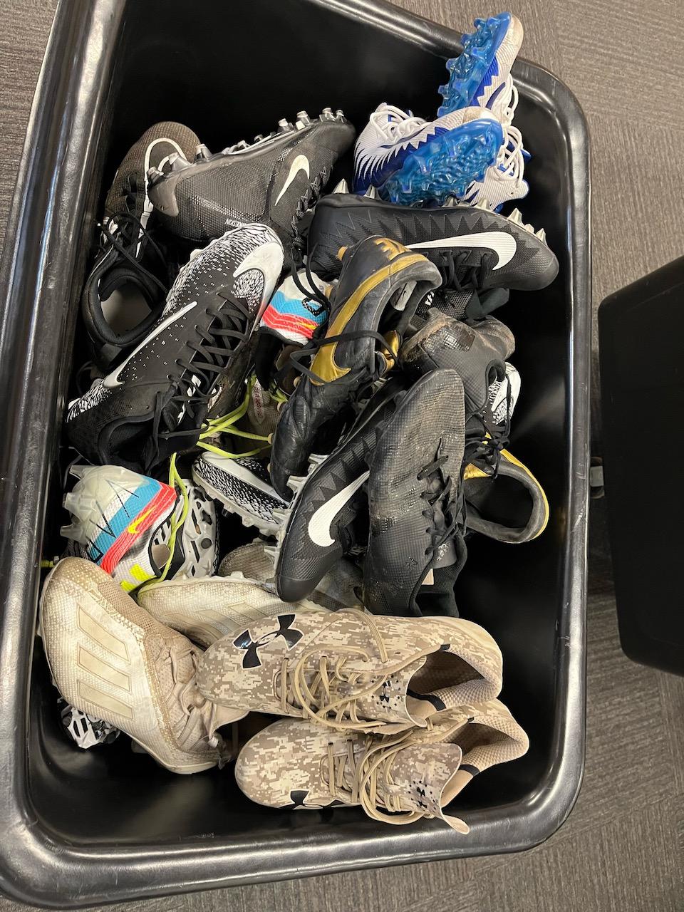 Loc: FH. Lot of Assorted used Men's Cleats (cube truck/cart not included)