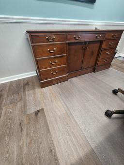 Executive office furniture with desk, chairs, and Lenovo dual monitors and keyboard