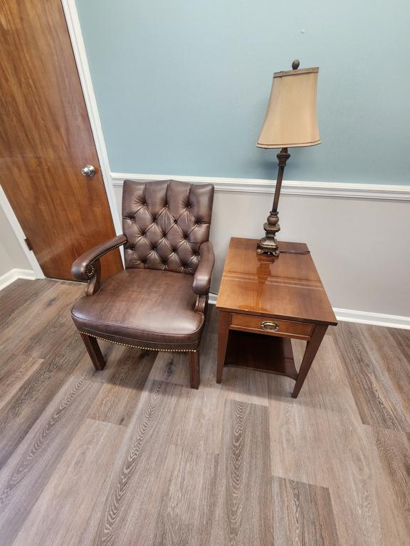 Executive office furniture with desk, chairs, and Lenovo dual monitors and keyboard