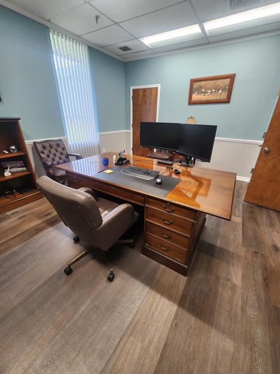 Executive office furniture with desk, chairs, and Lenovo dual monitors and keyboard