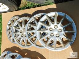 Two Sets of Four Hubcaps Plus One Extra