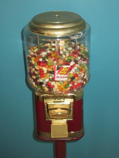 2 Gumball Machine Plastic Globe Sitting on Red Metal Base Stands Operated Mechanically Coin