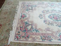 HANDMADE CHINESE SCULPTED AREA RUG IN IVORY, MAUVE AND GREEN. MEASURES APPROXIMATELY 5 FT 7 IN X 9