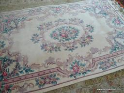 HANDMADE CHINESE SCULPTED AREA RUG IN IVORY, MAUVE AND GREEN. MEASURES APPROXIMATELY 5 FT 7 IN X 9