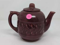 SIGNED USA BURGUNDY GLAZED CERAMIC TEA POT WITH LID & RAISED DETAILING. IT MEASURES APPROX. 7" X 4"