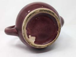 SIGNED USA BURGUNDY GLAZED CERAMIC TEA POT WITH LID & RAISED DETAILING. IT MEASURES APPROX. 7" X 4"