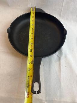 Two cast iron pans. Cast by Calphalon. 11".