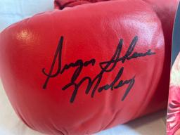 Autographed Everlast Boxing Glove signed by Sugar Shane Mosley with photo of signing.