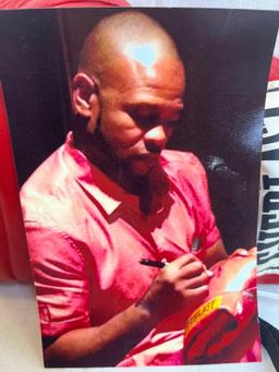 Autographed Everlast Boxing Glove signed by Sugar Shane Mosley with photo of signing.