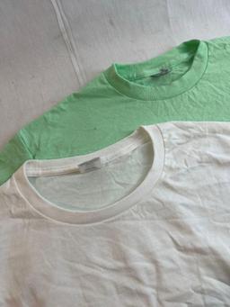 Solid t-shirt lot. Three white, one green. Size medium and Large....