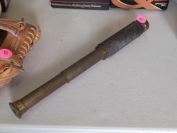 (LR) ANTIQUE BRASS TELESCOPE WITH LEATHER BAND. NOTE, BAND IS COMING OFF. 12" LONG FULLY EXTENDED.