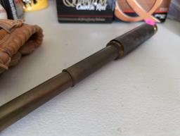 (LR) ANTIQUE BRASS TELESCOPE WITH LEATHER BAND. NOTE, BAND IS COMING OFF. 12" LONG FULLY EXTENDED.