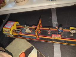 (LR) WIND UP TIN TOY, MAIN STREET, THE TURN KEY WORKS HOWEVER THE STRING THAT OPERATES THE ACTION OF