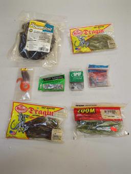 Gray container and contents including worms, various fishing lures, and other fishing accessories.