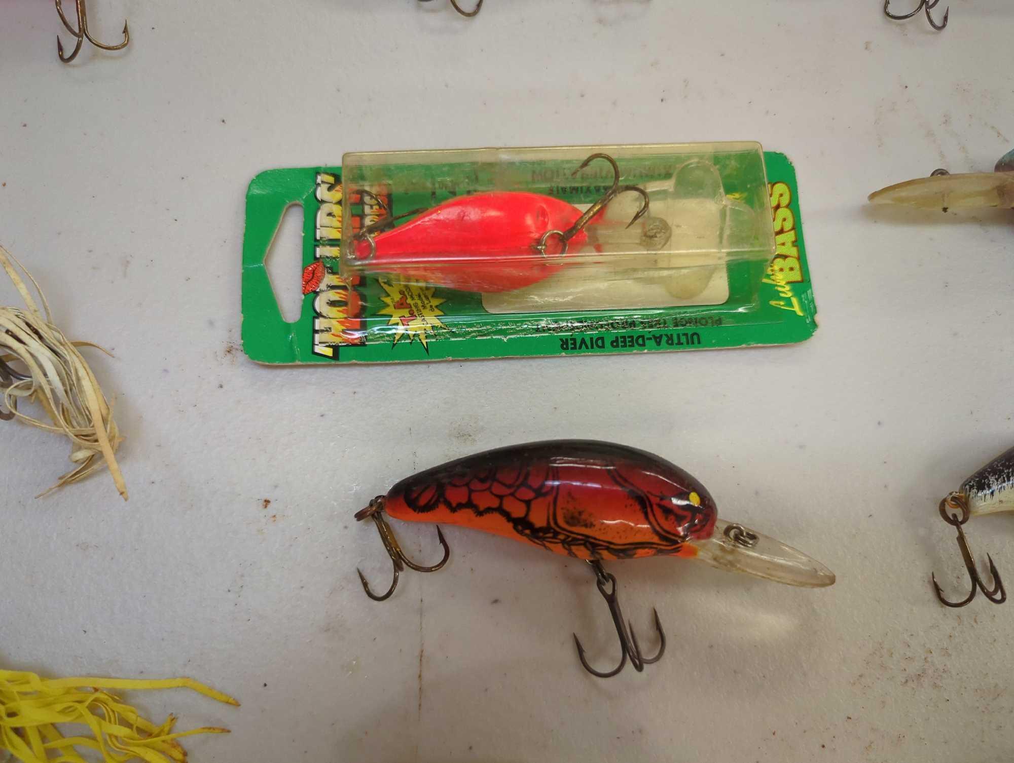 Tackle Box and contents including various fishing lures of similar style. Comes as is shown in