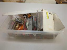 White Sterilite organizer tote filled with packaged fishing lures. Comes as is shown in photos.