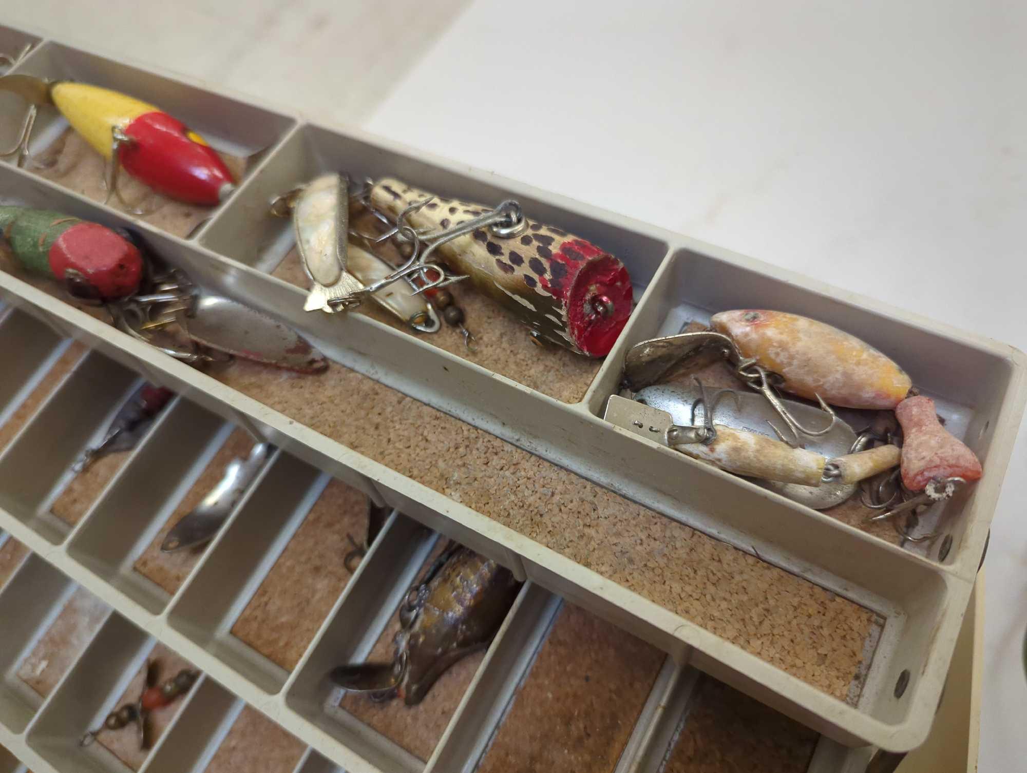 Large tackle box and contents including various fishing lures of similar style. Comes as is shown in