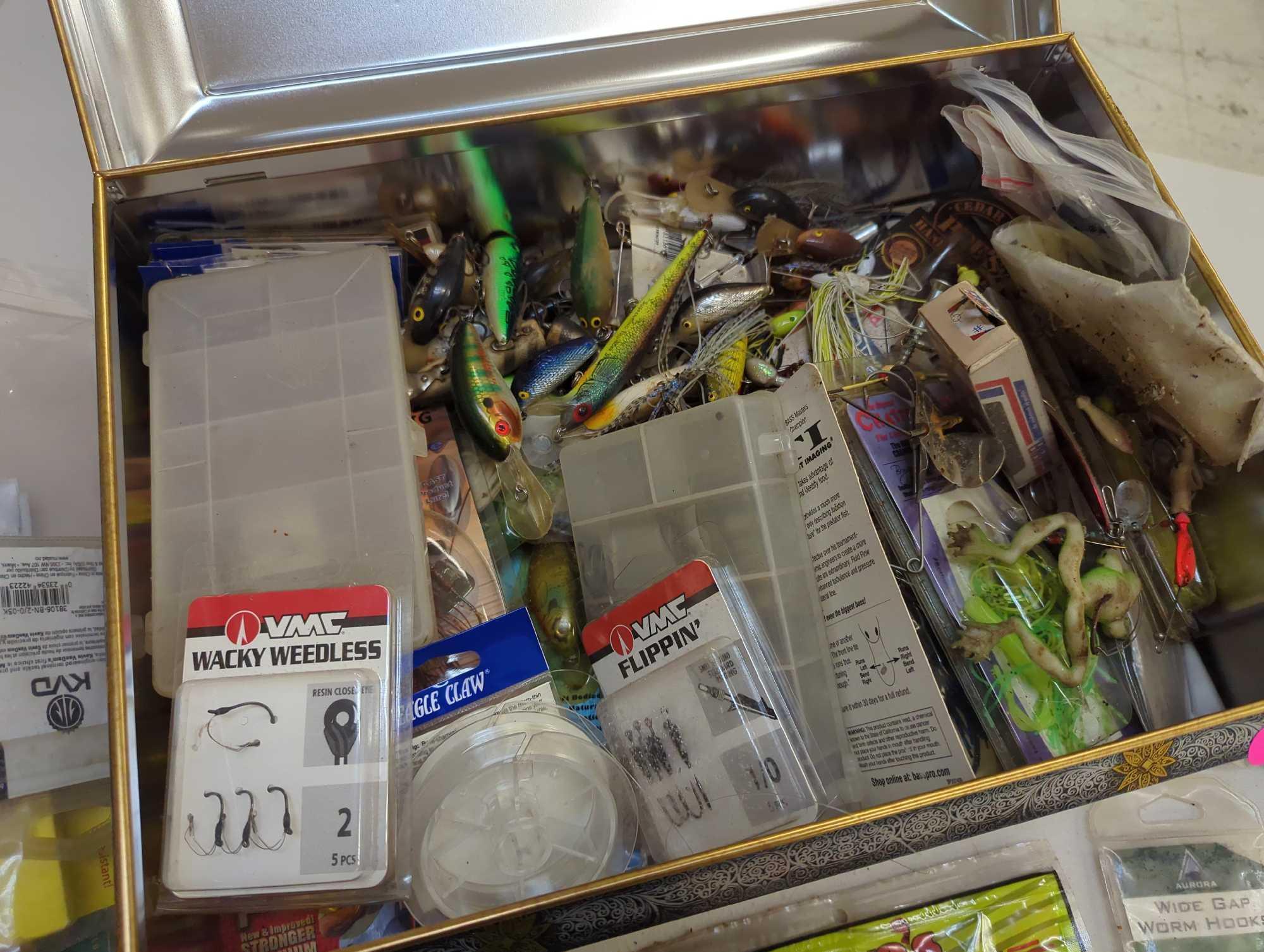 Large tin and contents including various fishing lures and fishing accessories. Comes as is shown in