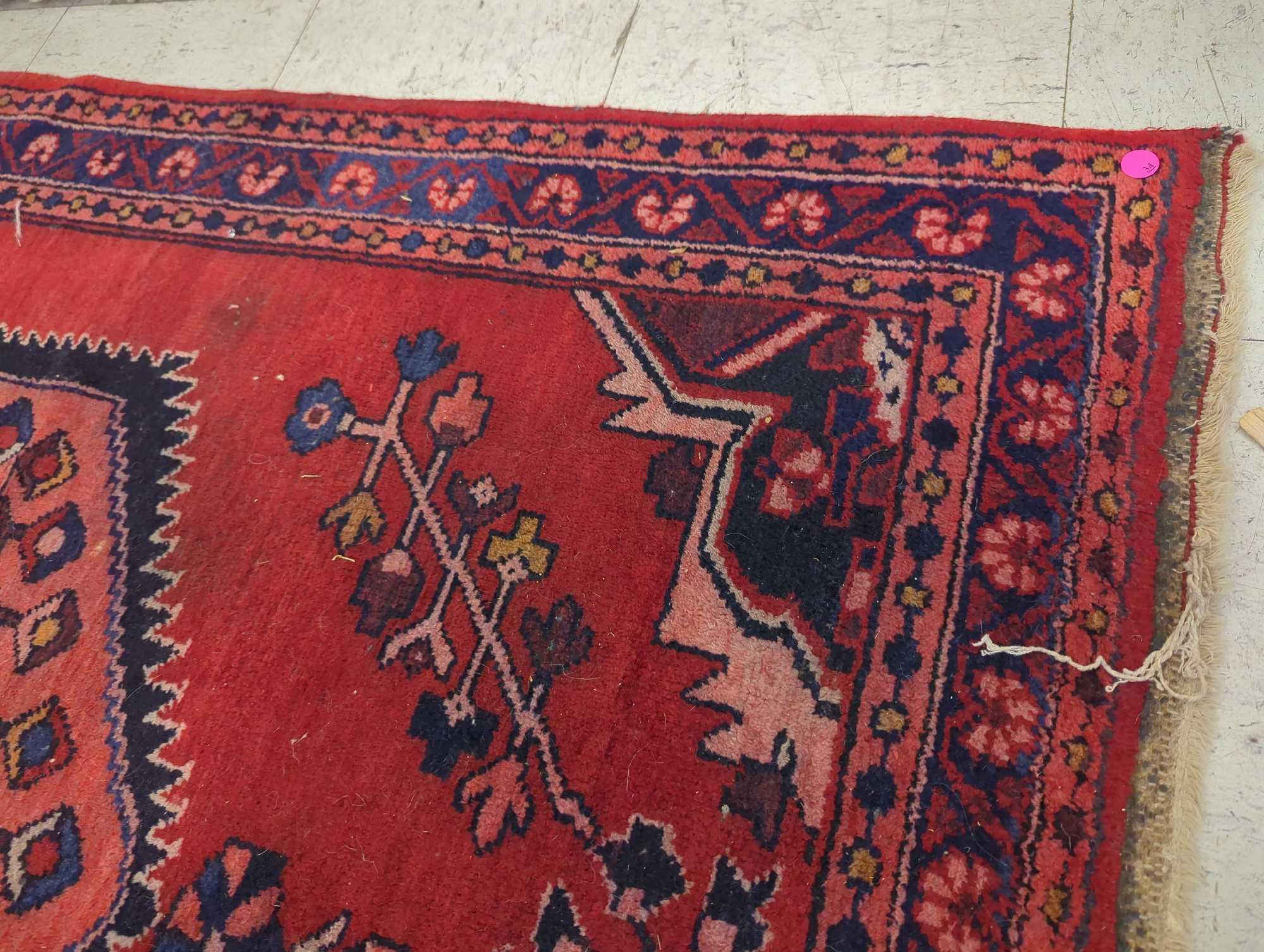 HAND MADE ANTIQUE AREA RUG. FLORAL ACCENTS, RED, AND DARK BLUE. 44 1/2"X60"