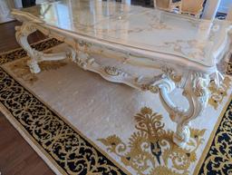 SILIK MINERVA DINING ROOM TABLE WITH GLASS TOP. STENCILED DETAILING ON TOP. CARVED/FLORAL DETAILING.