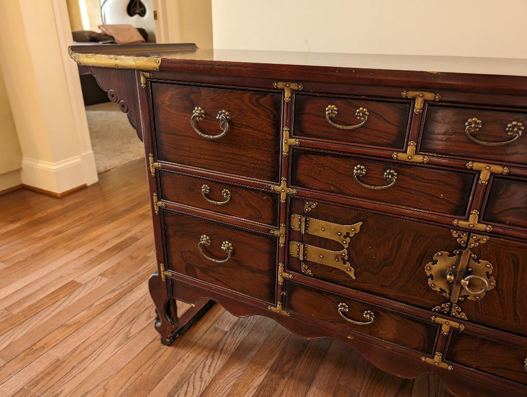 KOREAN BRASS ACCENTED BUFFET/SIDEBOARD. FEATURES MULTIPLE DRAWERS AND SINGLE CABINET.