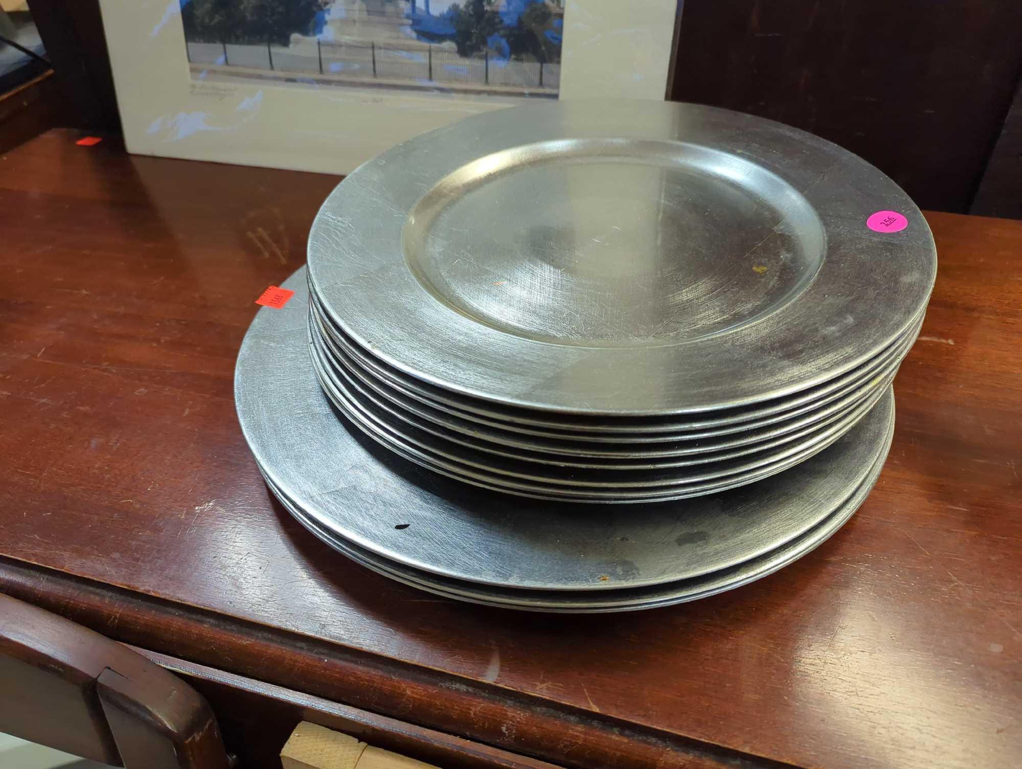 Set of 11 silver plastic charger plates. Comes as is shown in photos. Appears to be used.