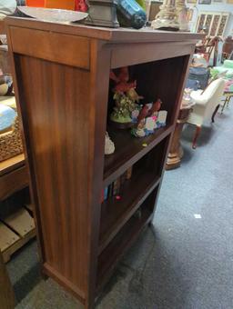 Three-shelf wooden bookcase. Comes as is shown in photos. Appears to be used. Surrounding items not