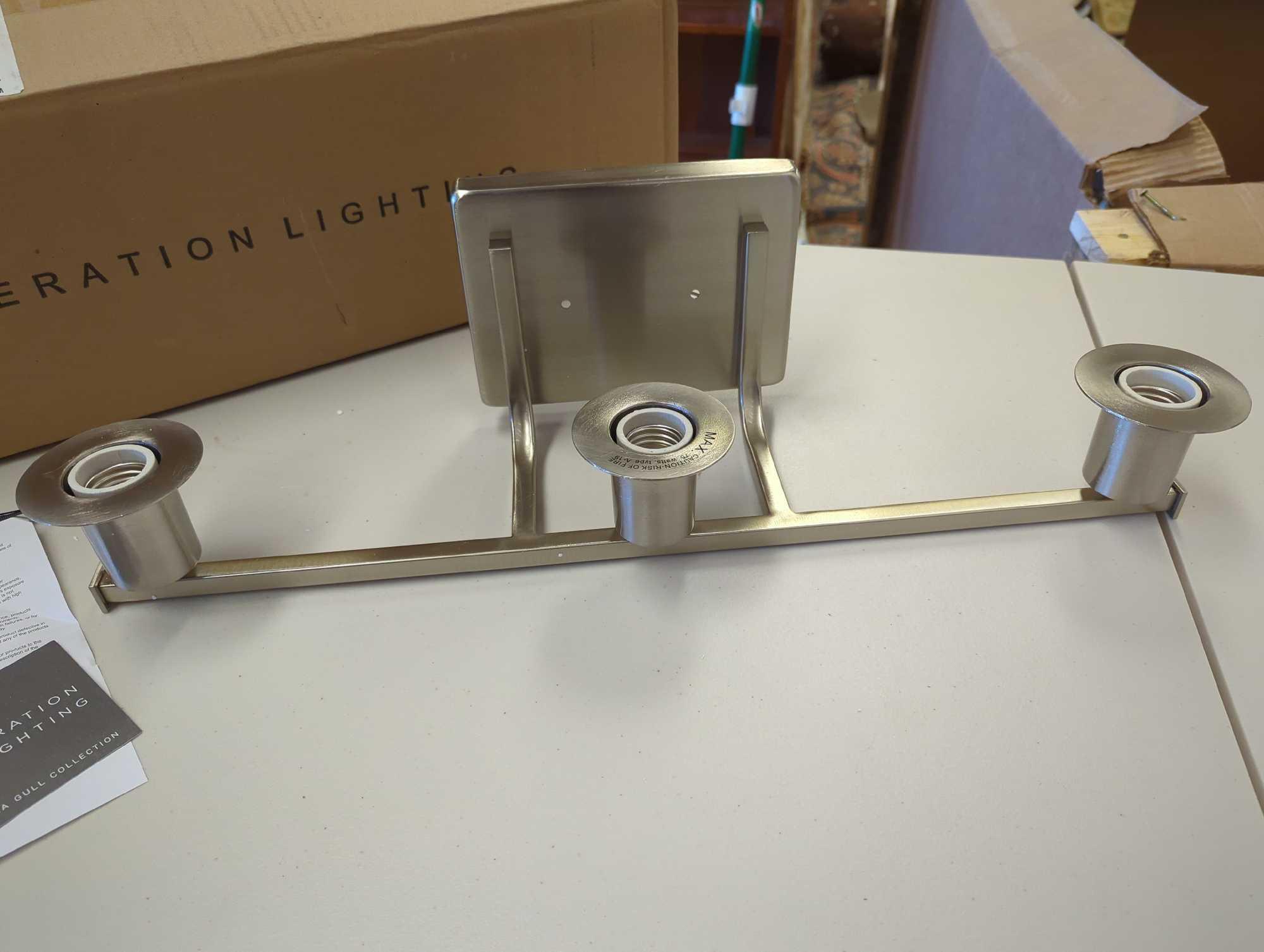 Generation Lighting Brut 3-Light Brushed Nickel Bathroom Vanity Light. Comes as is shown in photos.