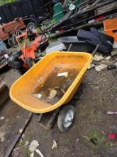 Yellow Plastic Wheelbarrow with Metal Frame and Pneumatic Tires
