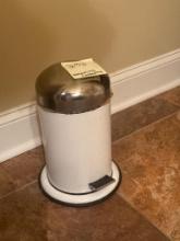 Contents of a Bathroom Including Trash Can, Stand, and Cleaning Products
