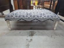 Upholstered Ottoman with Distressed Wood Legs and Geometric Fabric Design