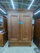 Large Wooden Armoire with Carved Detailing and Bottom Drawers