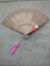 Carved Wooden Folding Hand Fan with Pink Tassel Accent