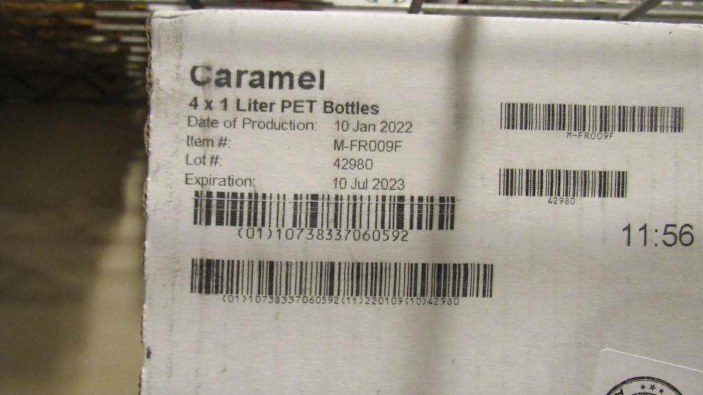8) BOTTLES OF MONIN CARAMEL GOURMET SYRUP.