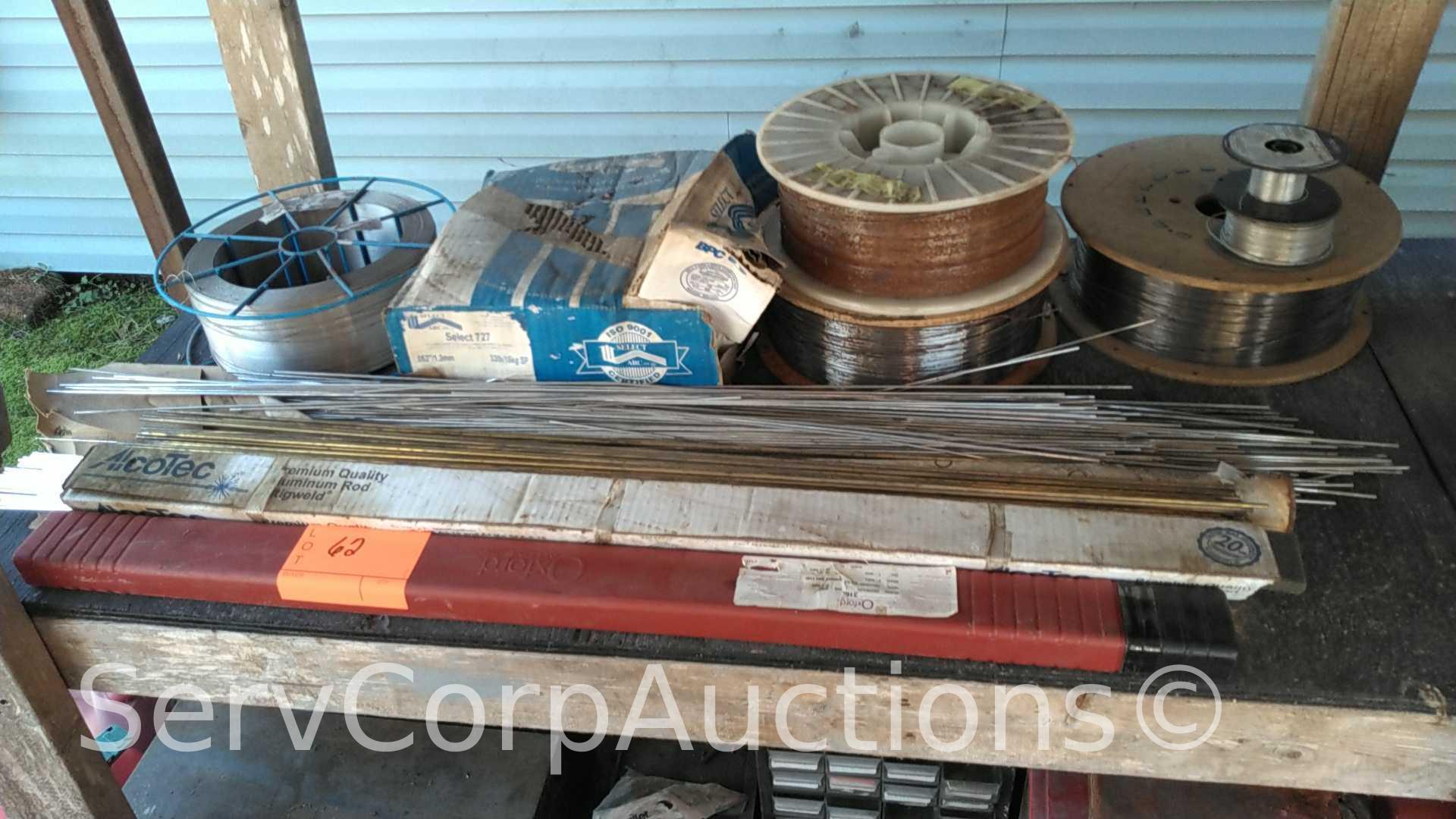 Lot on Shelf of Various Tigweld Rods & Wire Feeder Rolls