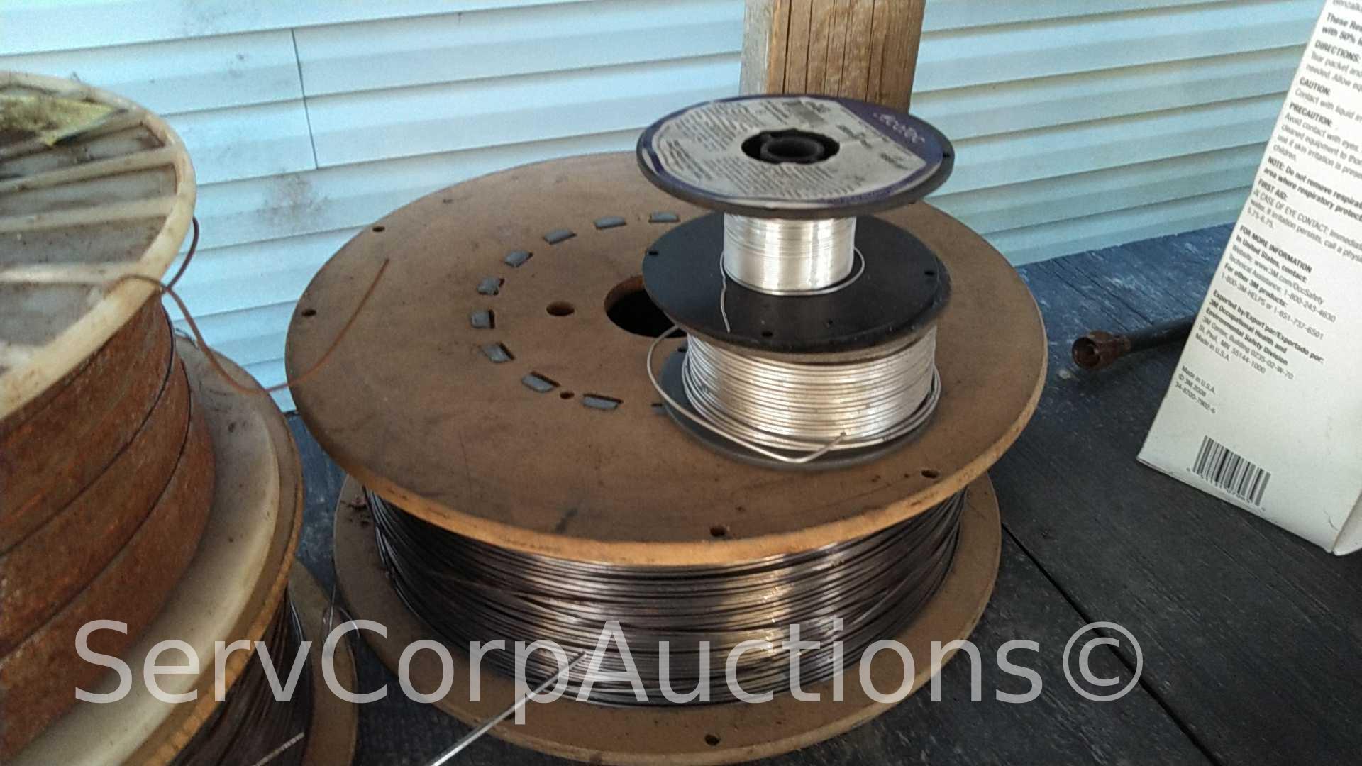 Lot on Shelf of Various Tigweld Rods & Wire Feeder Rolls