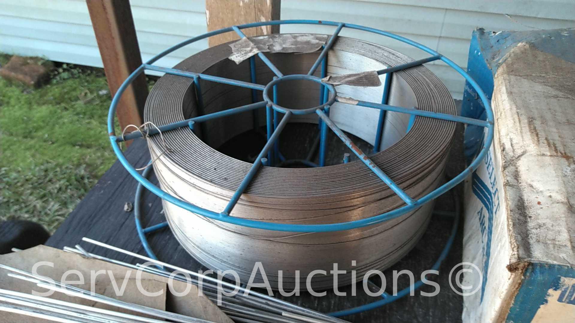 Lot on Shelf of Various Tigweld Rods & Wire Feeder Rolls