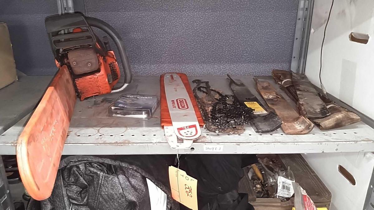 Lot on Shelf of Husqvarna Chainsaw, Various Chainsaw Bars, Chainsaw Chains, Lawnmower Blades