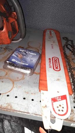 Lot on Shelf of Husqvarna Chainsaw, Various Chainsaw Bars, Chainsaw Chains, Lawnmower Blades