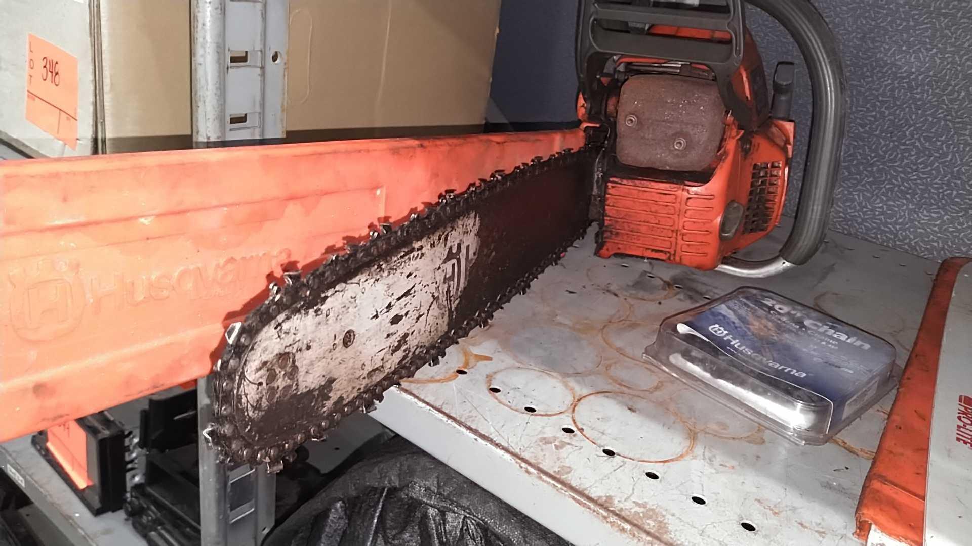 Lot on Shelf of Husqvarna Chainsaw, Various Chainsaw Bars, Chainsaw Chains, Lawnmower Blades