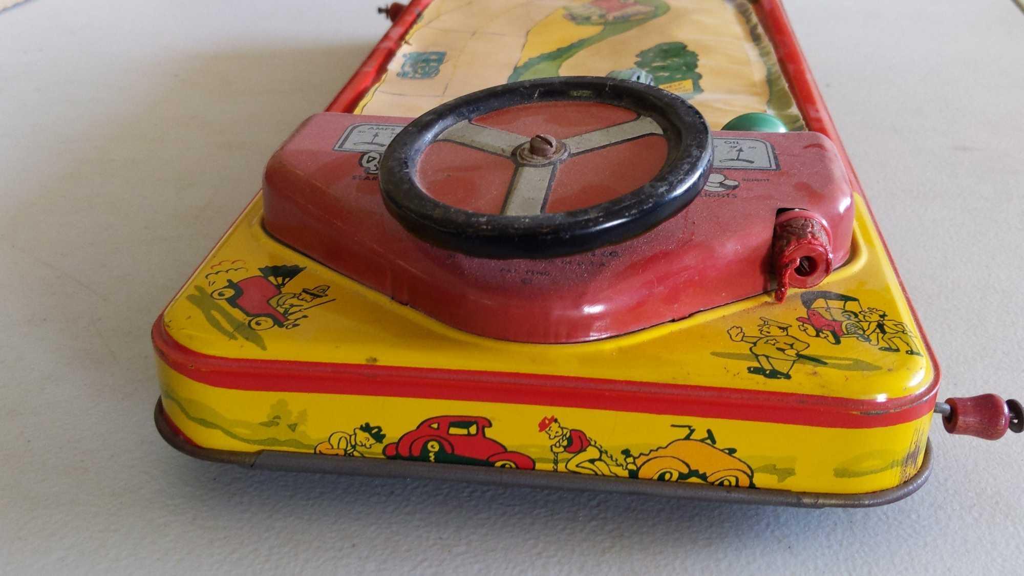 Crank Action Tin Driving Game - Scroll Ripped & Horn Missing