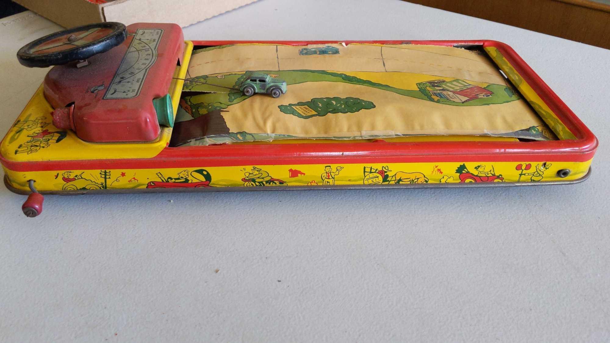 Crank Action Tin Driving Game - Scroll Ripped & Horn Missing