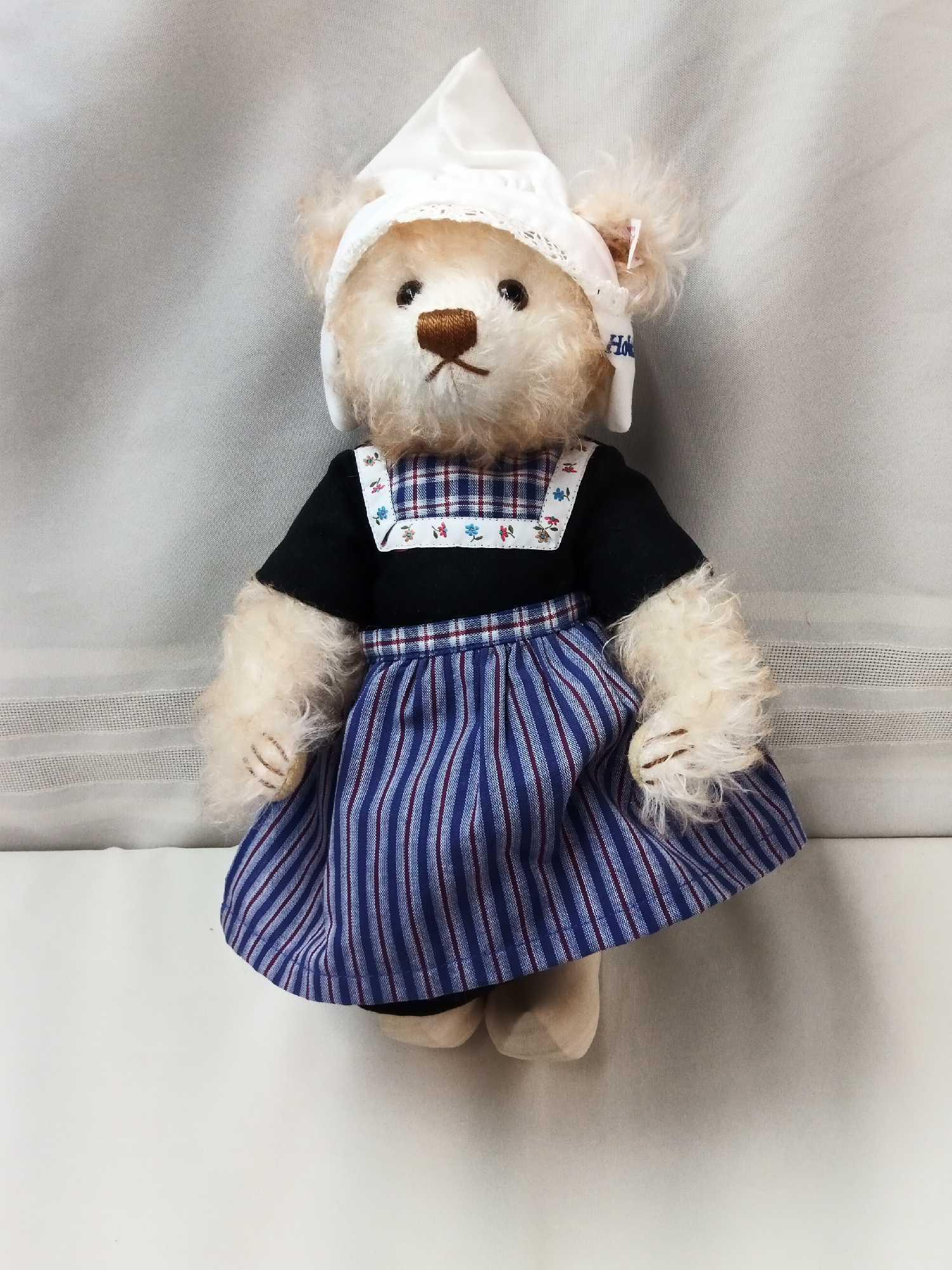 STIEFF BEAR. BUFF COLOR 12" DRESSED IN HOLLAND STYLE DRESS, CAP, AND WOODEN SHOES