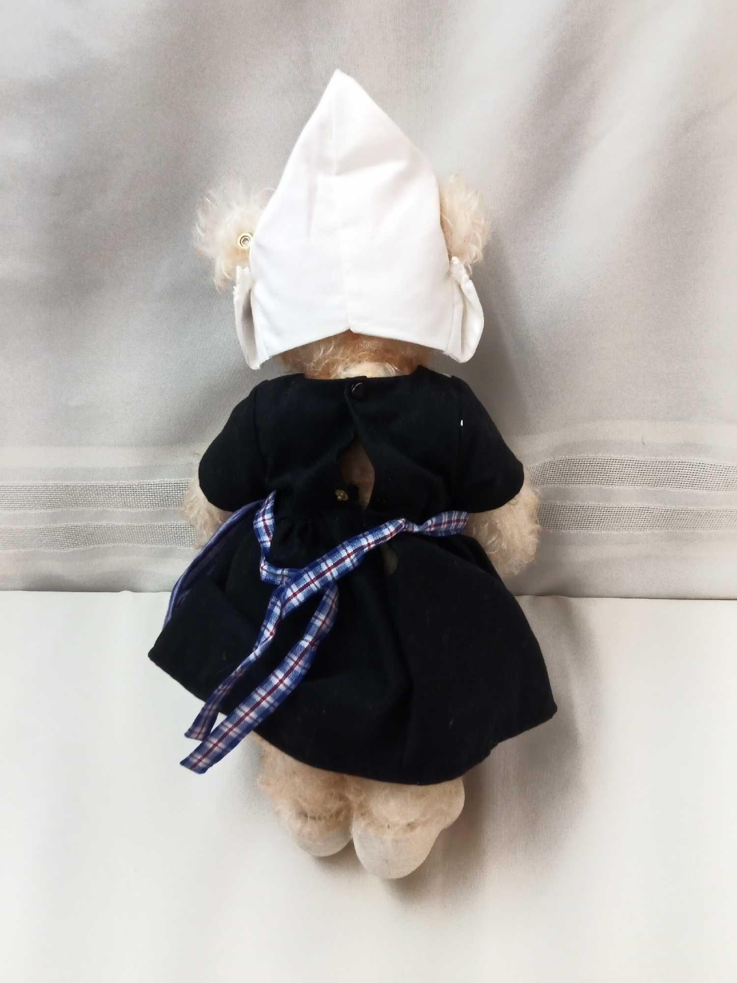 STIEFF BEAR. BUFF COLOR 12" DRESSED IN HOLLAND STYLE DRESS, CAP, AND WOODEN SHOES