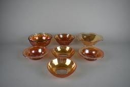 Lot of Seven Small Marigold Carnival Glass Bowls of Various Patterns & Makers