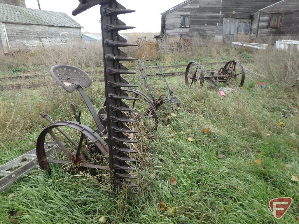 Huge scrap iron package on rural building site, includes several pieces of scrap farm equipment