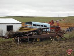 Huge scrap iron package on rural building site, includes several pieces of scrap farm equipment