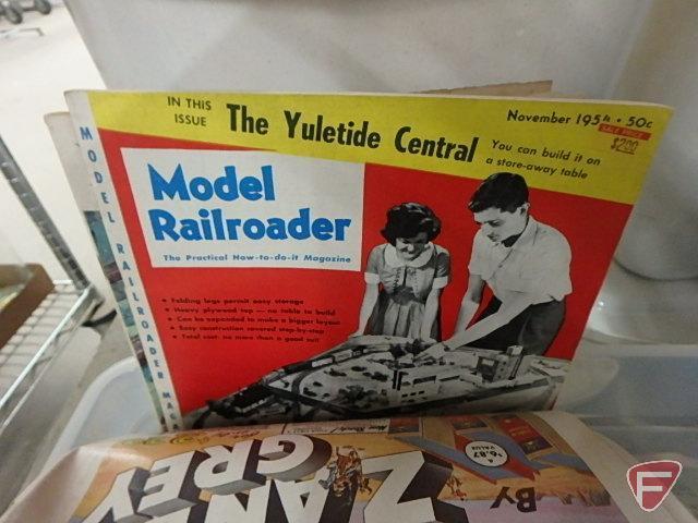 Train set, some Northern Pacific cars, tracks, transformer, and railroad books