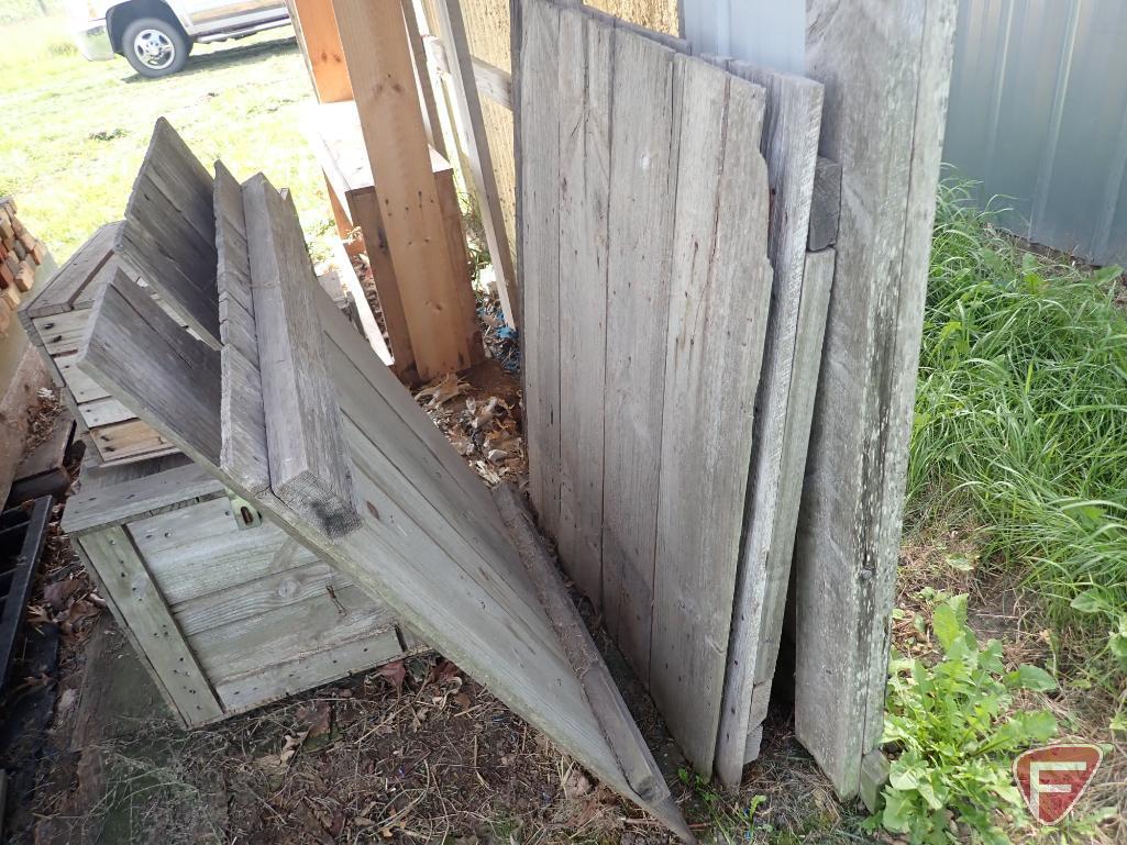 Contents of shed; lumber, bricks, wood crates, wood shelf, wood fence panels, plastic pallets