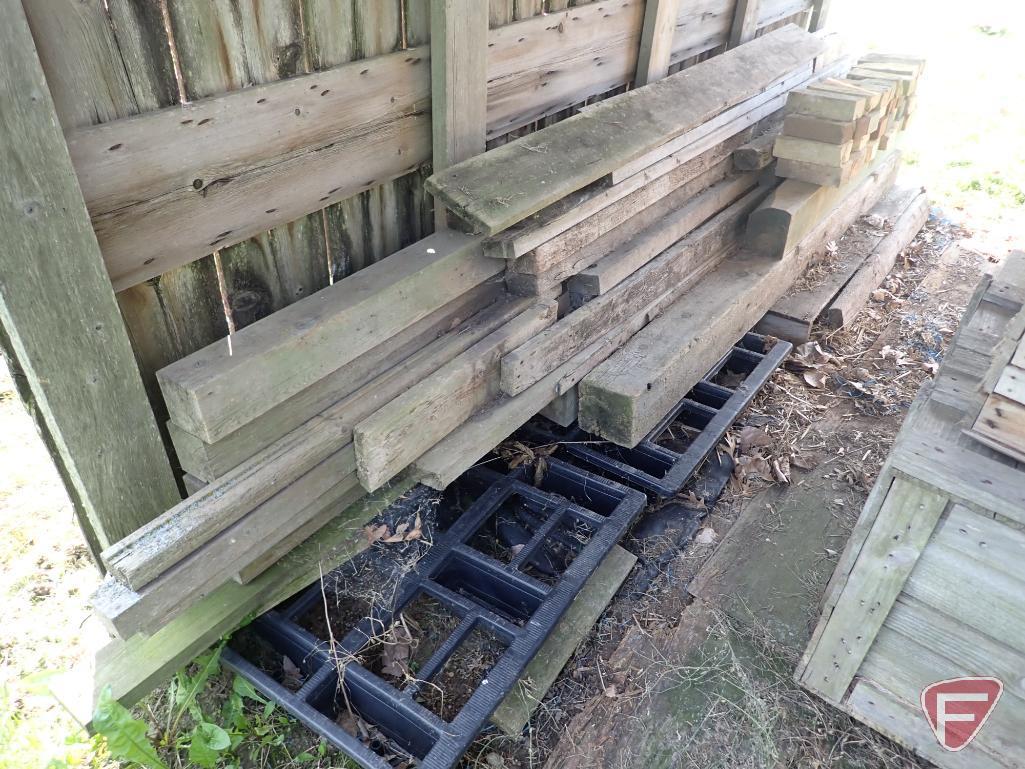 Contents of shed; lumber, bricks, wood crates, wood shelf, wood fence panels, plastic pallets